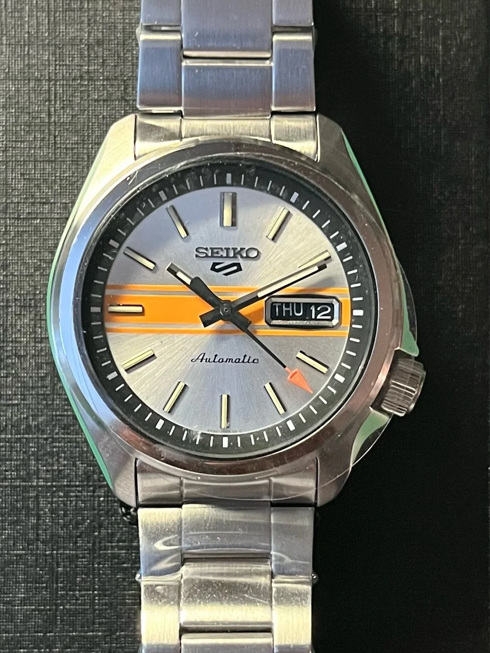Seiko : Retro GT dial. Silver Dial Watch with Orange Stripe Accent SRPE55